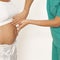 Nurse examines a pregnant woman