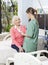 Nurse Examining Blood Pressure Of Senior Woman