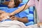 Nurse examining pregnant woman with stethoscope at maternity ward