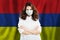 Nurse with face mask against national flag Armenia. Flu epidemic and virus protection concept