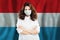 Nurse with face mask against national flag Luxembourg. Flu epidemic and protection concept
