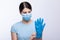 Nurse with face mask wear and checking protective gloves