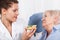 Nurse feeding elderly woman