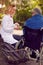 Nurse giving medicine to senior man in wheelchair outdoor