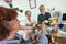 Nurse giving medicine to seniors at nursing home