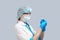 Nurse on a gray background in a protective mask and glasses, holds a syringe with a vaccine.Coronavirus treatment