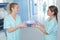 Nurse handing packages to colleague