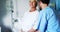 Nurse having a converstaion with smiling female senior patient