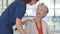 Nurse helping senior patient on wheelchair