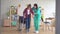 Nurse helps a disabled girl to get up from a wheelchair after an injury