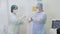 Nurse helps a surgeon to put on sterile gloves before sclerotherapy surgery in hospital