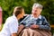 Nurse holding hands with senior woman in wheelchair