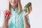 Nurse holds apple and avocado, healthy diet plan concept