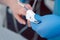 Nurse in hospital putting blood pressure sensor on patient`s finger