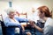 Nurse interacting with a senior woman in wheelchair