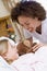 Nurse Laughing With Her Young Patient