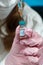 Nurse loading vaccine into syringe