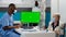 Nurse looking at greenscreen display with paralyzed patient