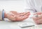 Nurse measures the level of sugar in the blood of businessman