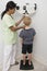 Nurse Measuring Boy\'s Height