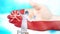 Nurse in medical mask and gloves washes large hand, painted in colors of Oman flag. State care for nation health. Wash