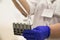 A nurse in medical uniform in blue latex gloves holds test tubes. laboratory assistant holds test tube and pipette in hand