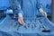 Nurse near table with different surgical instruments in operating room, closeup