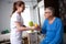 Nurse at nursing home brings orange juice to old patients