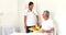 Nurse offering breakfast to senior man relaxing on bed