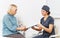 Nurse and an old patient in a clinic