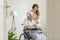 Nurse and patient in a wheelchair looking at photo album together and smiling