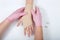 Nurse with pink gloves wrapping young girls hand with ace bandage
