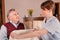 Nurse placing blanket on Senior man