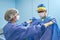 Nurse in preoperative room helps surgeon put on sterile gown