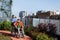 Nurse pushing senior man in wheelchair. Female caregiver and elderly man enjoying a warm autumn day in nursing home.