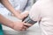 Nurse putting blood pressure cuff to patient