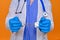 A nurse on a red background shows hands in handcuffs, closeup. Doctor arrested for a bribe from a patient, concept