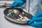 Nurse in rubber gloves holding a tray of surgical medical equipment