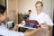 Nurse Serving A Patient A Meal In His Bed