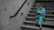 Nurse sitting on steps and writing on clipboard