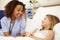 Nurse Sitting By Young Girl\'s Bed In Hospital