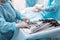 Nurse standing near table with laparoscopic instruments