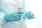 Nurse in sterile gown and gloves gives pill from pack