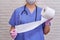 A nurse with a stethoscope holds a roll of toilet paper, close-up. Lack of toilet paper in the quarantine of coronavirus, the