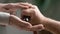 Nurse strokes hands of senior man holds cane closeup image