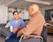 Nurse support disabled man in wheelchair with medical trust, wellness and aid in nursing home. Happy caregiver, patient