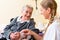 Nurse taking care of senior woman in retirement home