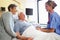 Nurse Talking To Senior Couple In Hospital Room