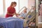 Nurse Talking To Senior Female Patient In Hospital Bed