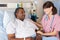 Nurse Talking To Senior Male Patient On Ward